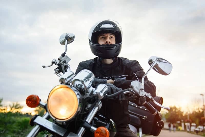 Biker wearing helmet on motorcycle