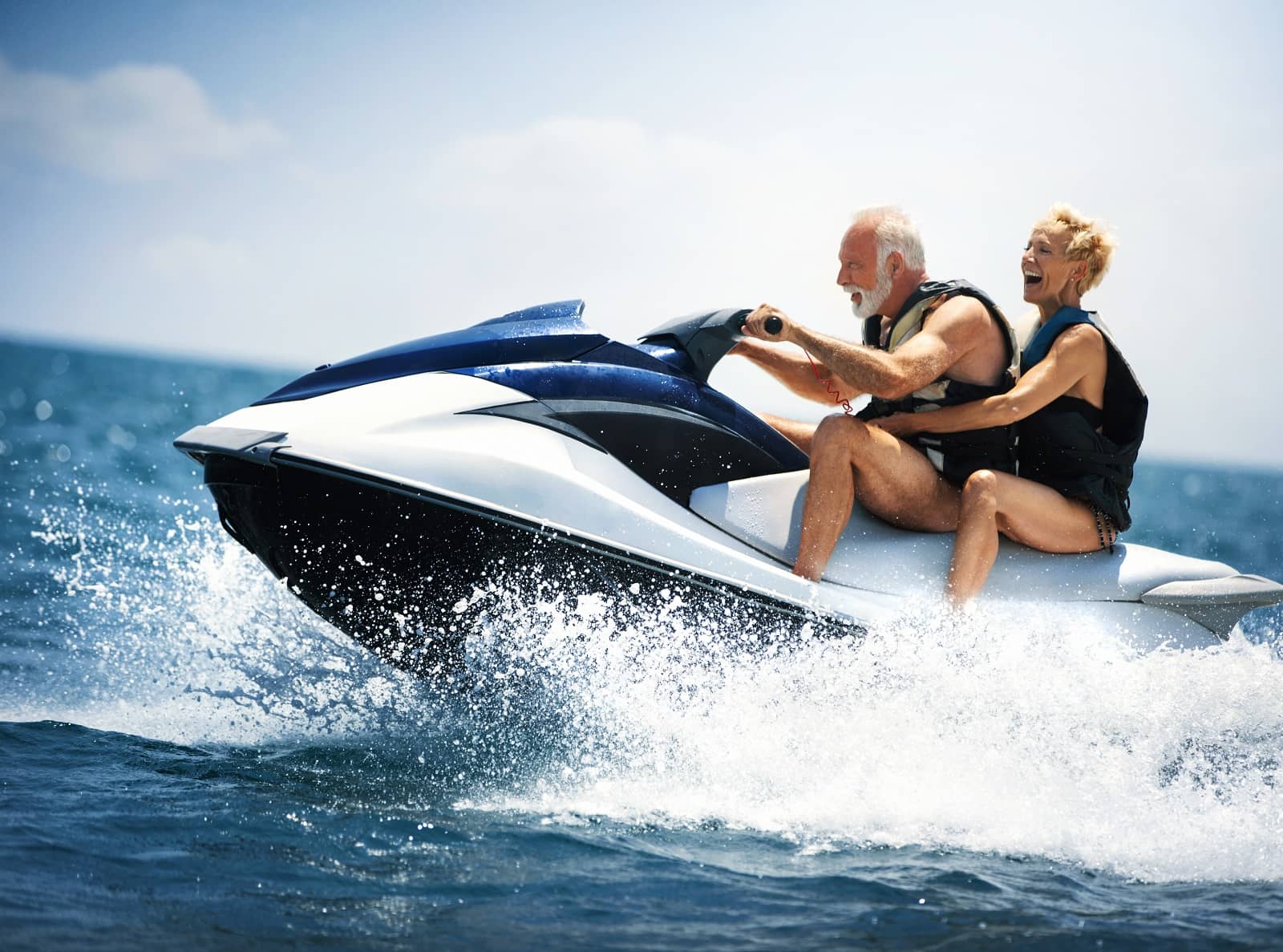 Older couple jet-skiing