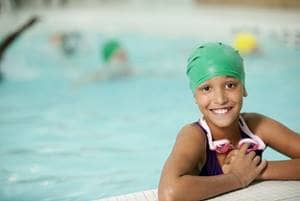 girl in pool with swim cap