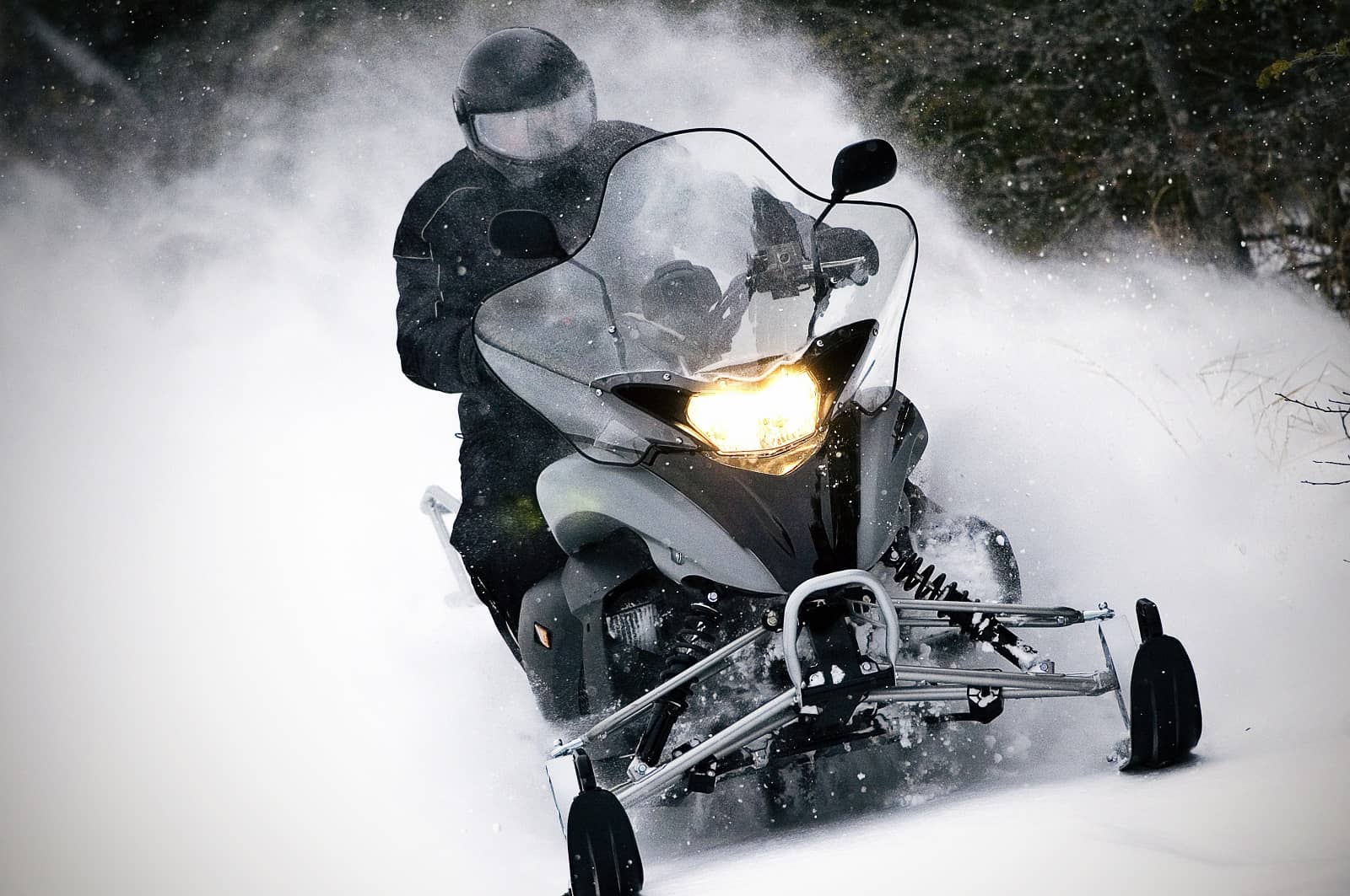 snowmobile kicking up snow