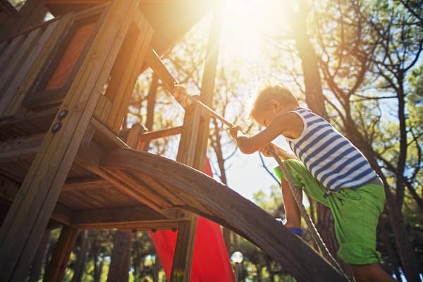 Boy climbing up rope