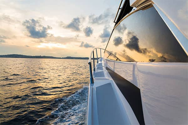 Yacht on ocean at sunset