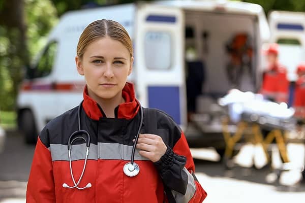 Paramedic in front of ambulance