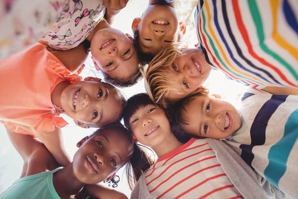 Kids huddled together smiling