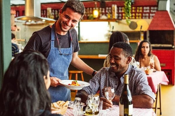 Waiter serving guests